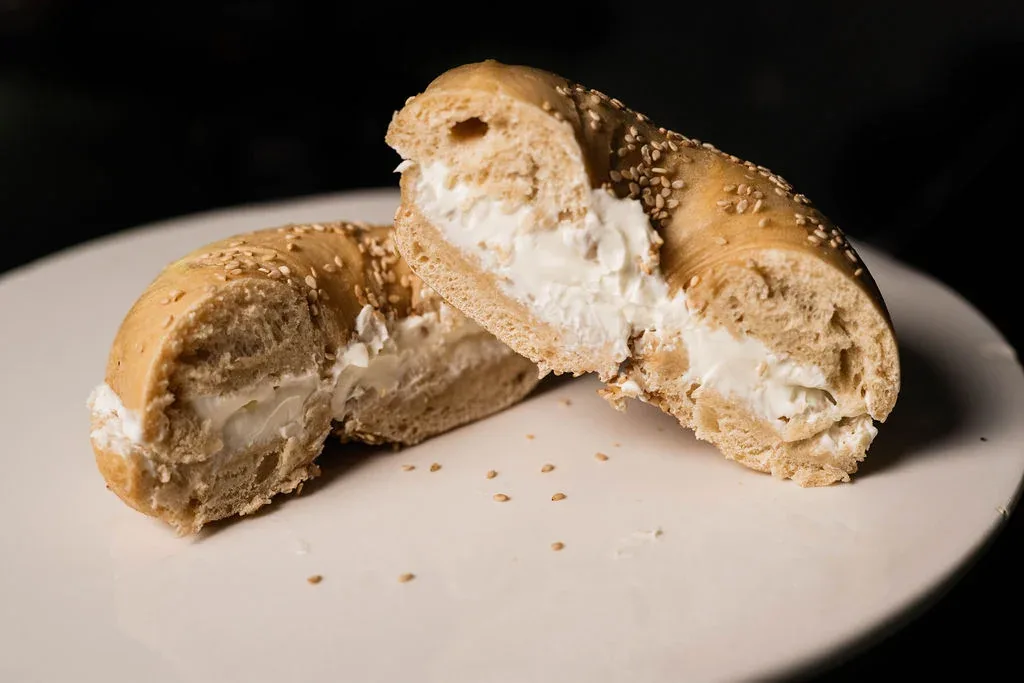 A fresh sesame bagel generously filled with house-made cream cheese